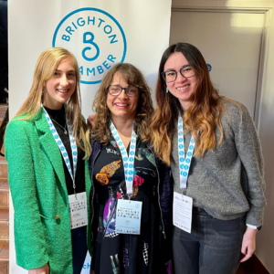 Rhianna, Helen, and Kim posing for a group photo after the Brighton Summit.